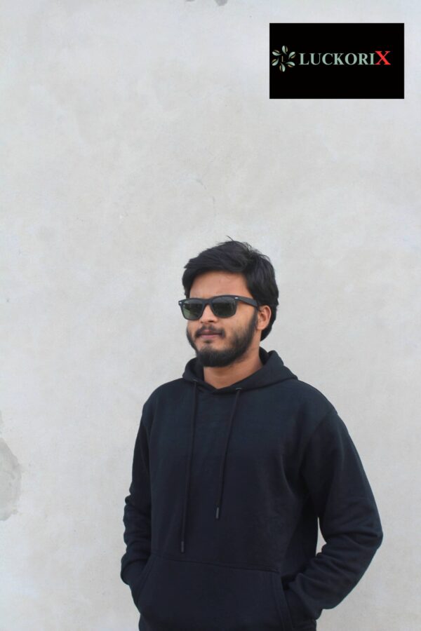 Front view of a man wearing a black hoodie from LuckoriX, styled with sunglasses, showcasing the hoodie’s sleek and versatile design.