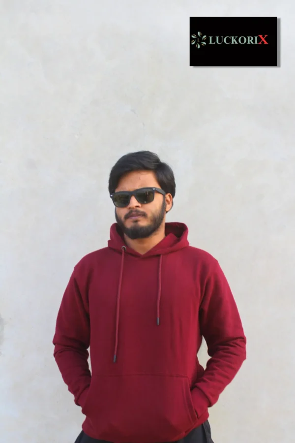 Front view of a man wearing a maroon hoodie from LuckoriX, paired with sunglasses, showcasing its stylish and premium design.