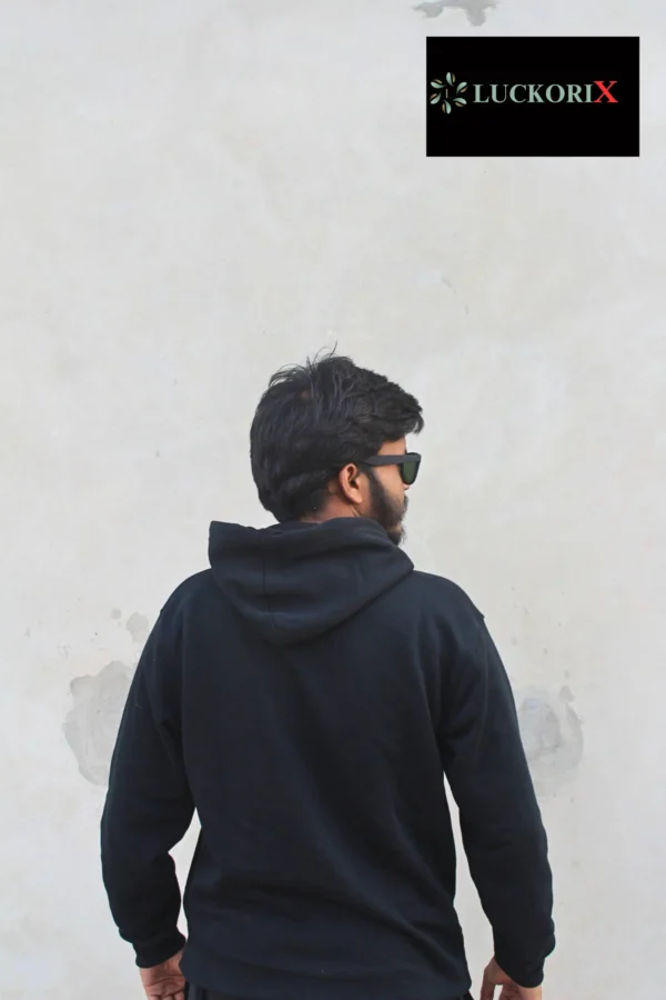 Back view of a man wearing a black hoodie from LuckoriX, paired with sunglasses, showcasing the hoodie’s stylish and minimalistic design.