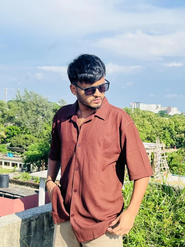 "Man modeling a rust brown textured short sleeve shirt from LuckoriX, styled for a relaxed summer look"