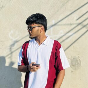"Man wearing a modern white and maroon color-blocked polo shirt from LuckoriX, standing confidently with a phone in hand"